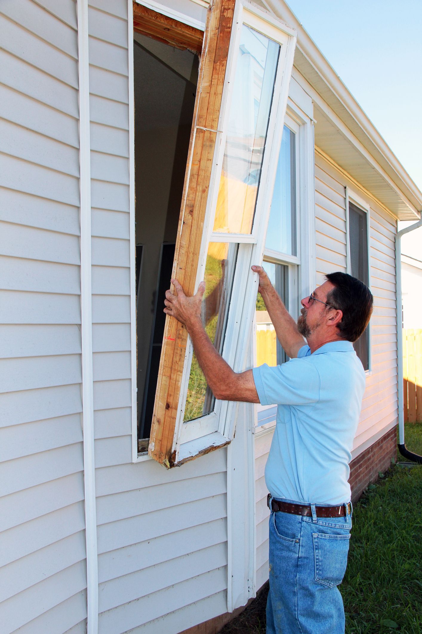 Window replacement by Midwest Window Company in Davenport, IA, with a contractor installing a new wi