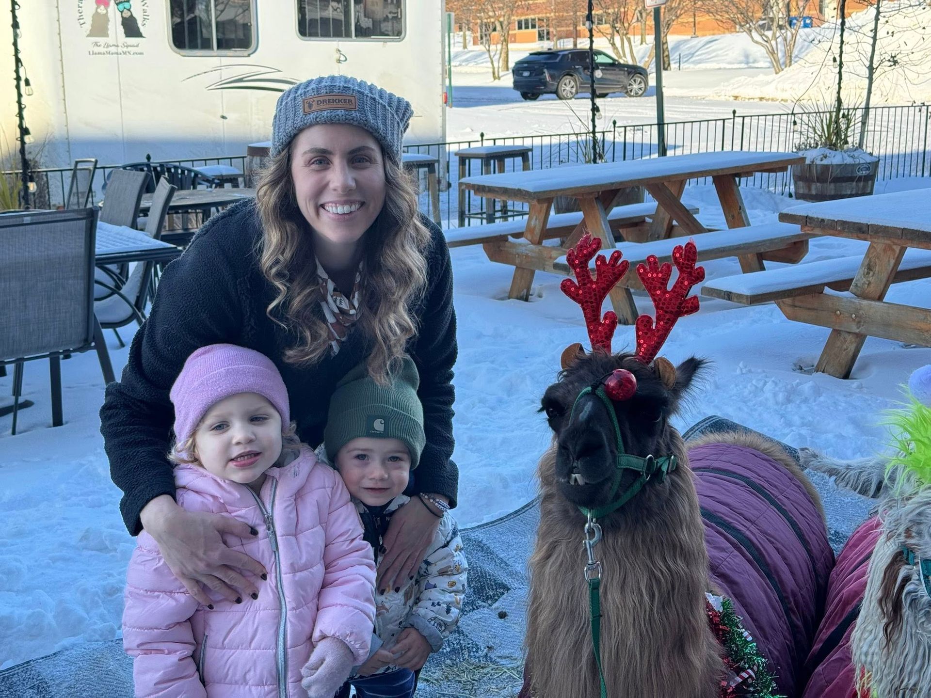 Family taking a photograph with a cute llama