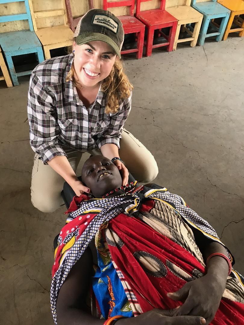 Helping medical issues internationally. Kyra, a chiropractor is adjusting a villager.