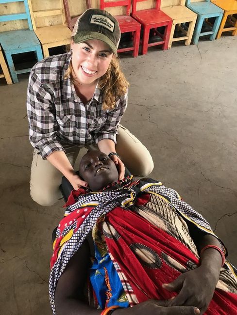 Helping medical issues internationally. Kyra, a chiropractor is adjusting a villager.