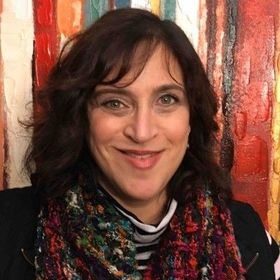 Rotary Club meeting; people seated at tables, speaker at podium showing a slide, American flag in background.