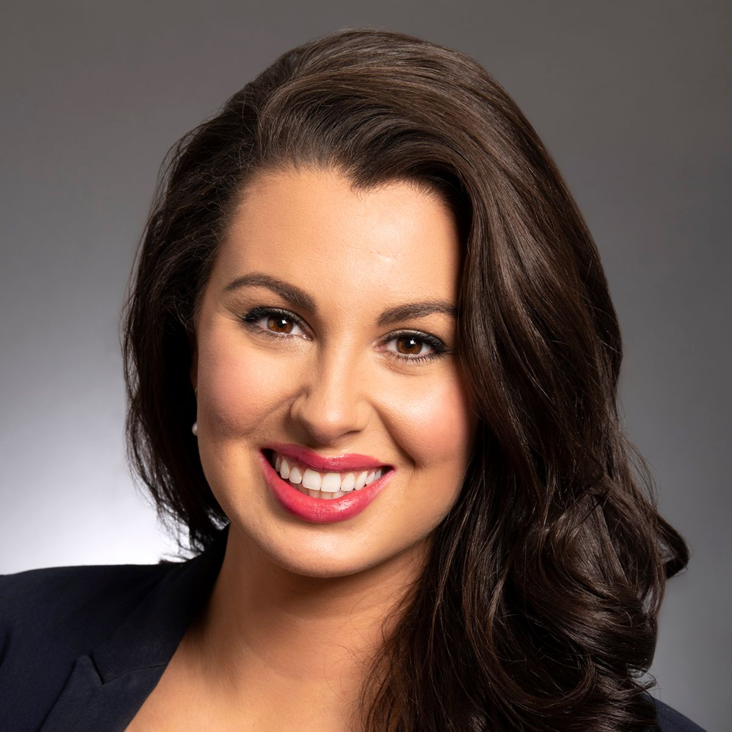Rotary Club meeting; people seated at tables, speaker at podium showing a slide, American flag in background.