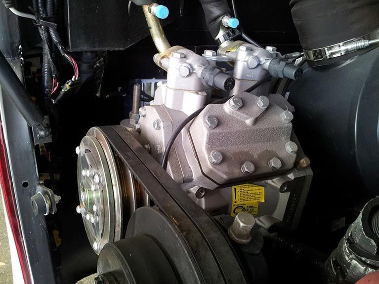 A close up of a compressor in a car
