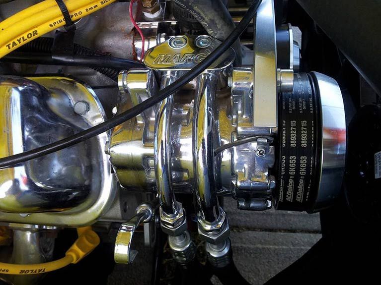 A close up of a taylor belt on a car engine