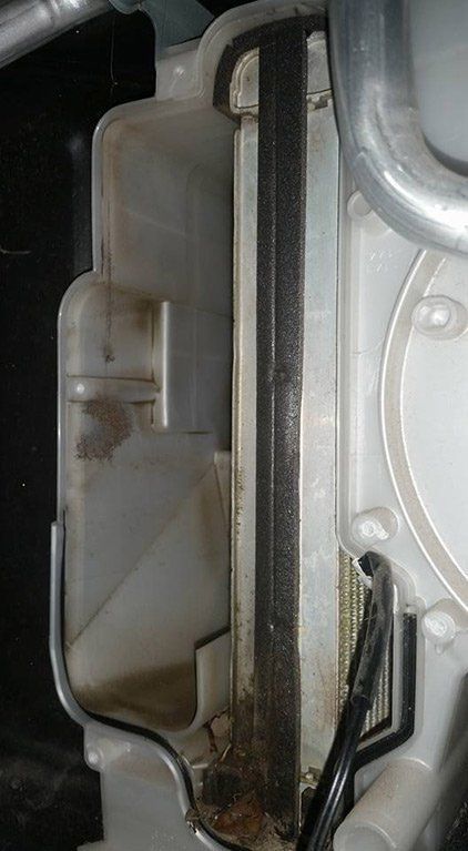 A close up of a dirty air filter on a car.