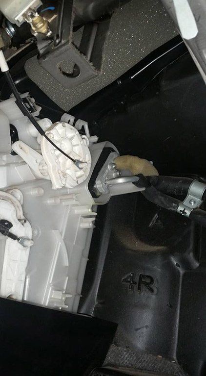 A close up of the inside of a car with a lot of wires coming out of it.