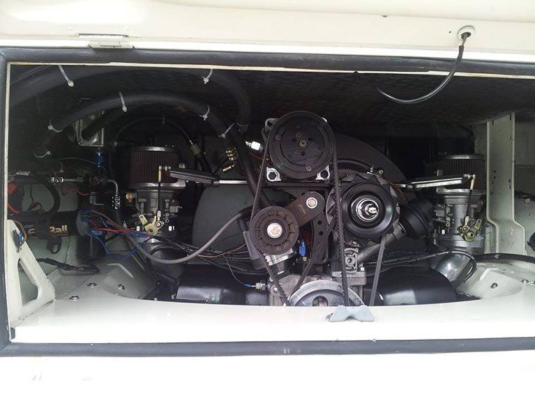 A close up of a car engine with the hood open