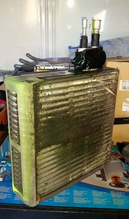 A green radiator is sitting on top of a table next to a box.