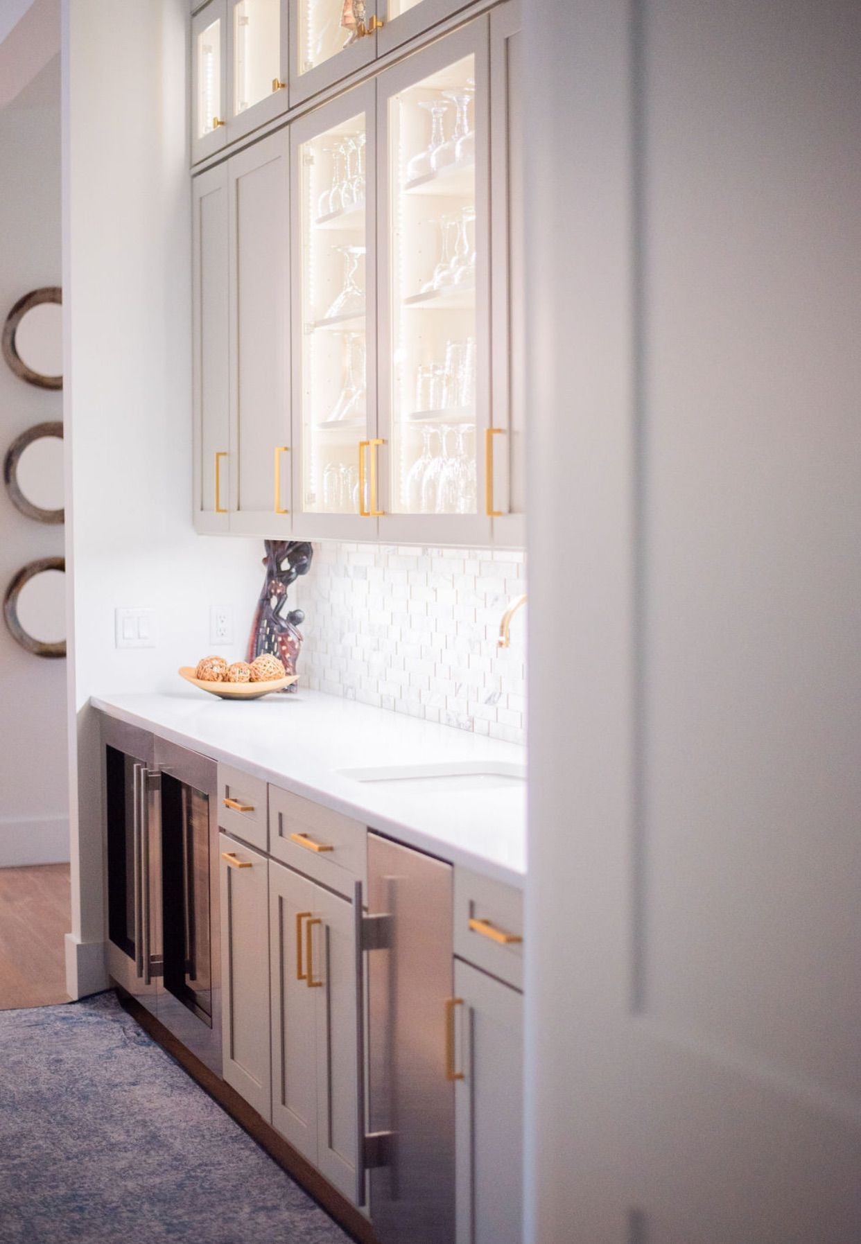 A kitchen with white cabinets and stainless steel appliances.