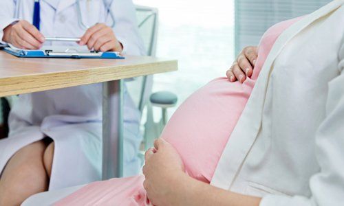 Pregnant Woman Talking to Her Doctor — Arlington, TX — Omega Ob-Gyn Associates