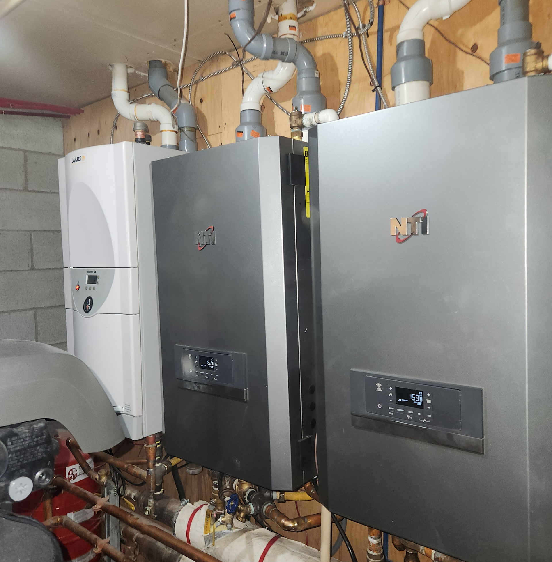 Une rangée de chaudières dans une pièce avec un autocollant qui dit « nt » dessus