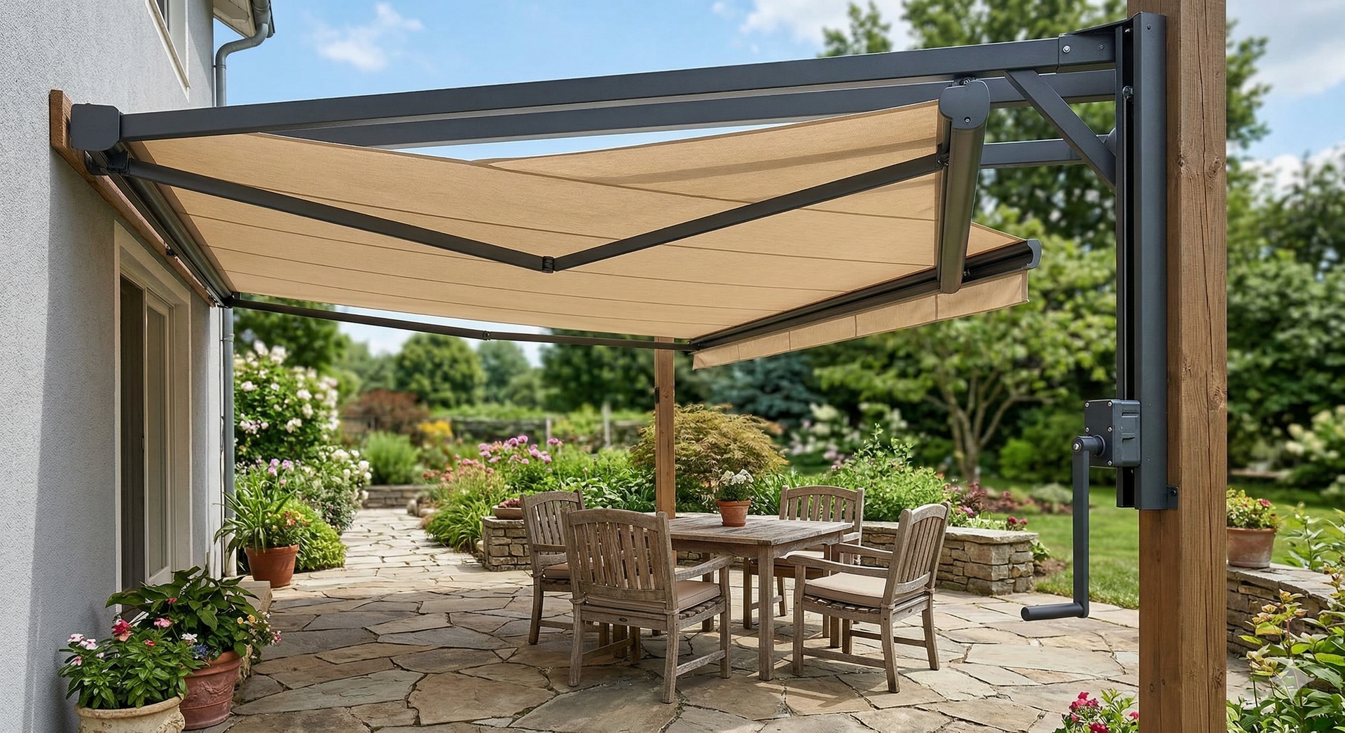 A beige retractable awning attached to a house wall and a wooden post, covering a stone patio with a dining set.