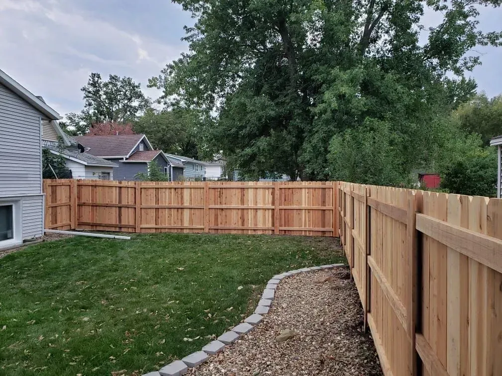 Backyard Wood Fence — Marshalltown, IA — Fencing Solutions