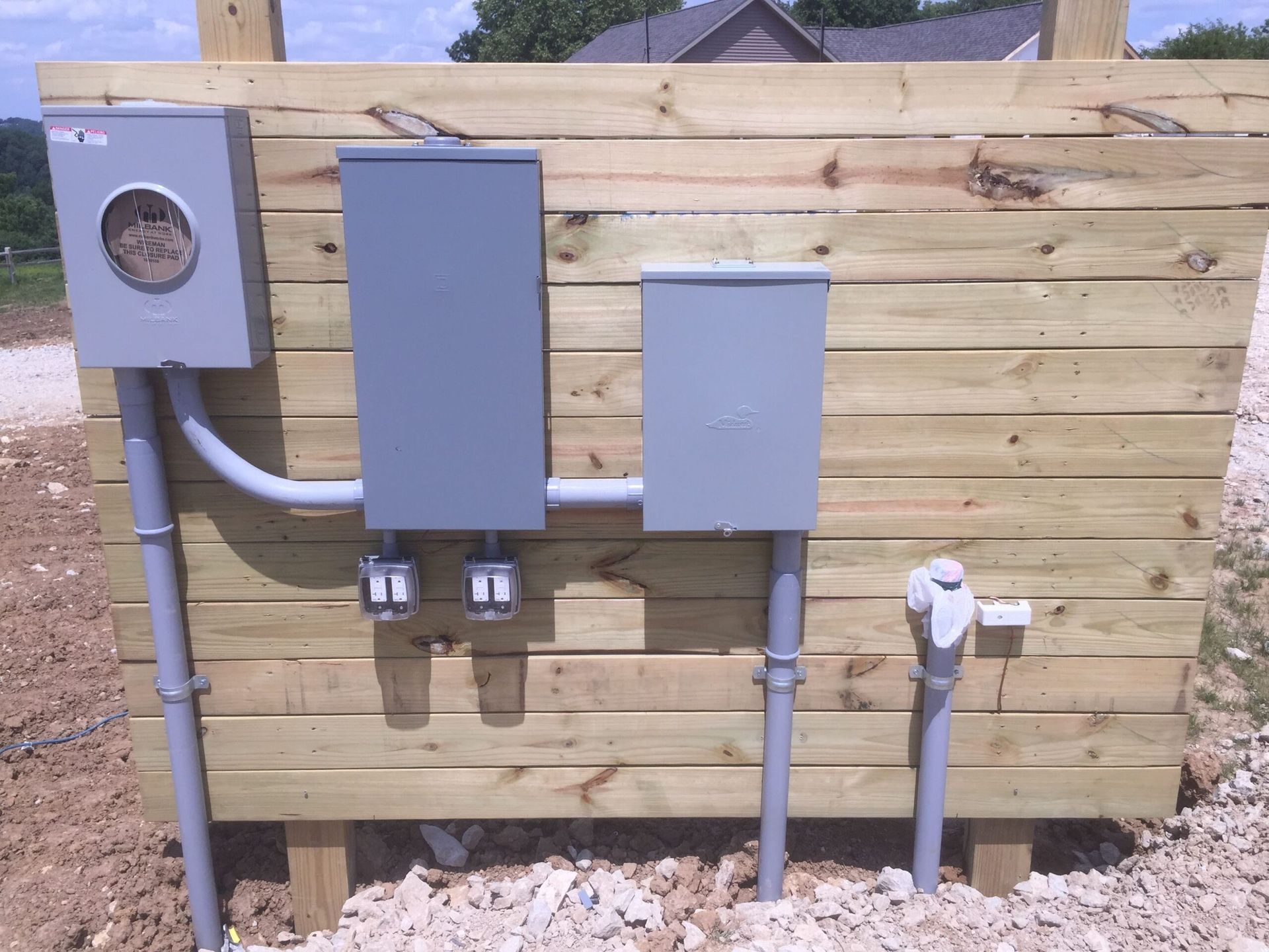 A Wooden Fence With Electrical Boxes — Rochester, MN — POWER PLUS ELECTRIC LLC