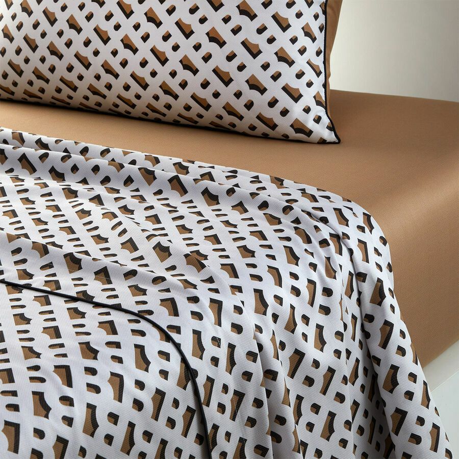 Un lit avec une couette et des oreillers à imprimé léopard