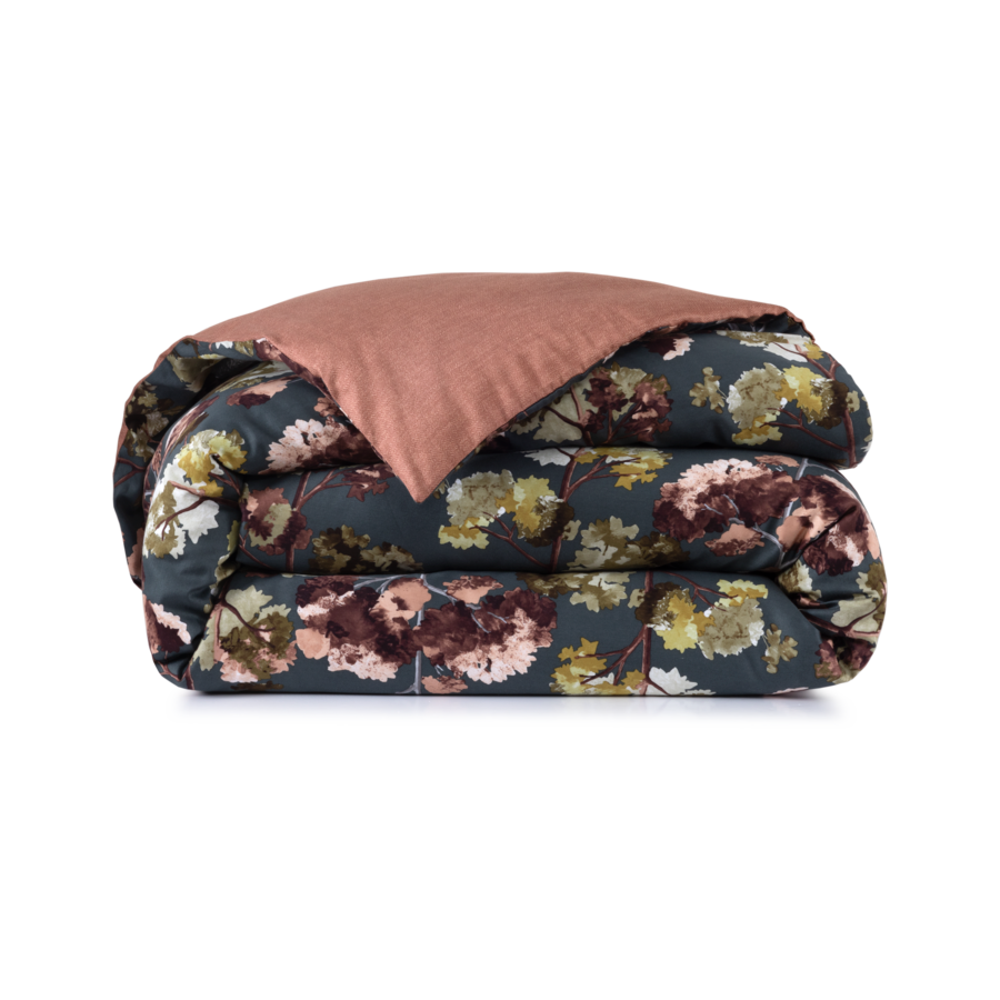 Folded floral patterned comforter with a solid rust-colored reverse side.