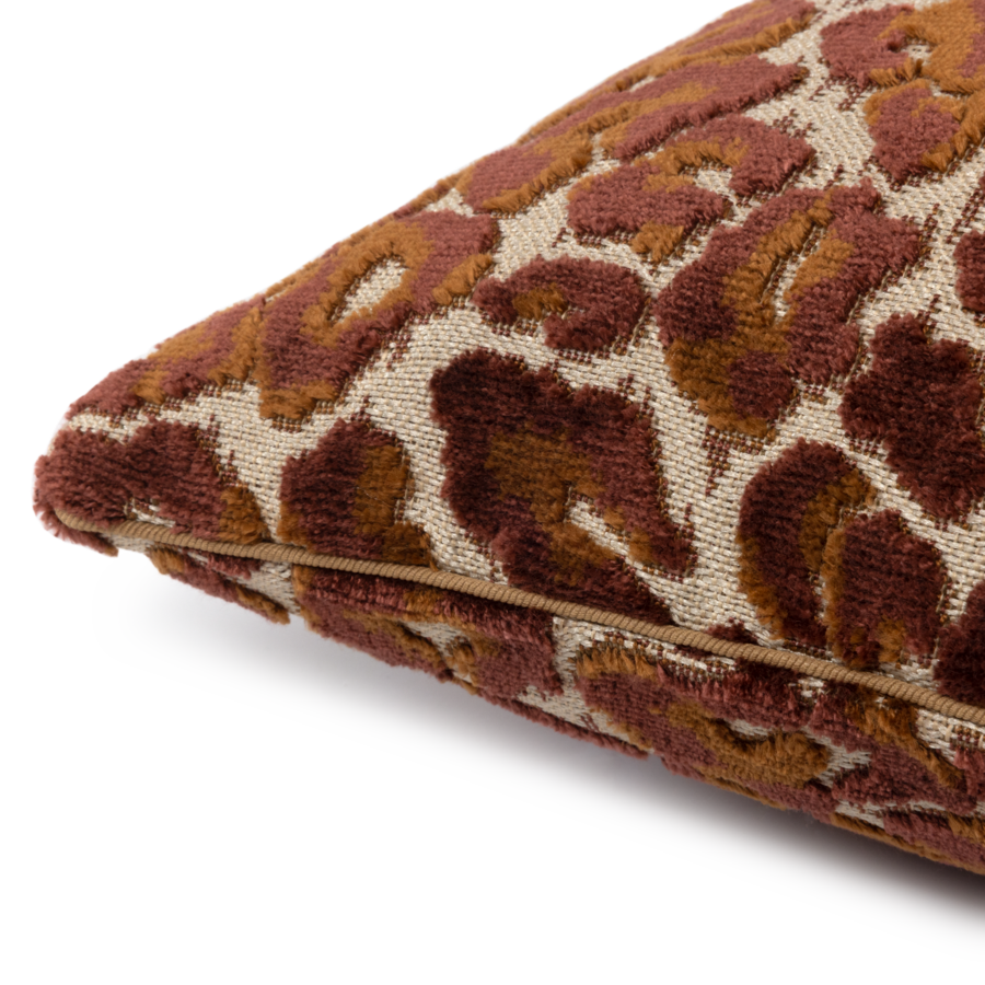 Gros plan sur un coussin décoratif à motif léopard marron et beige.