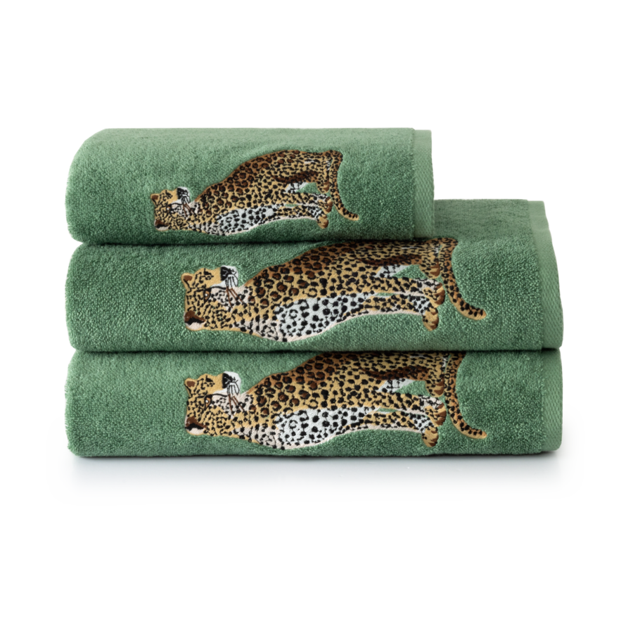 Des serviettes vertes empilées, brodées de guépards bondissants.