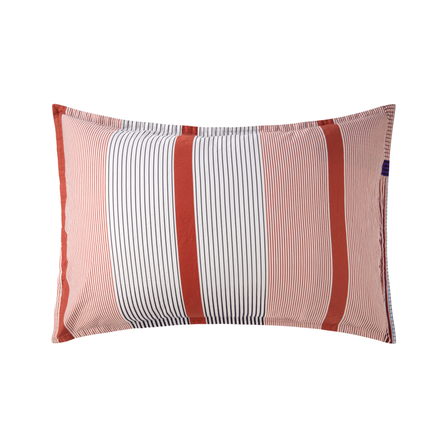 Un coussin rayé rouge et blanc sur fond blanc