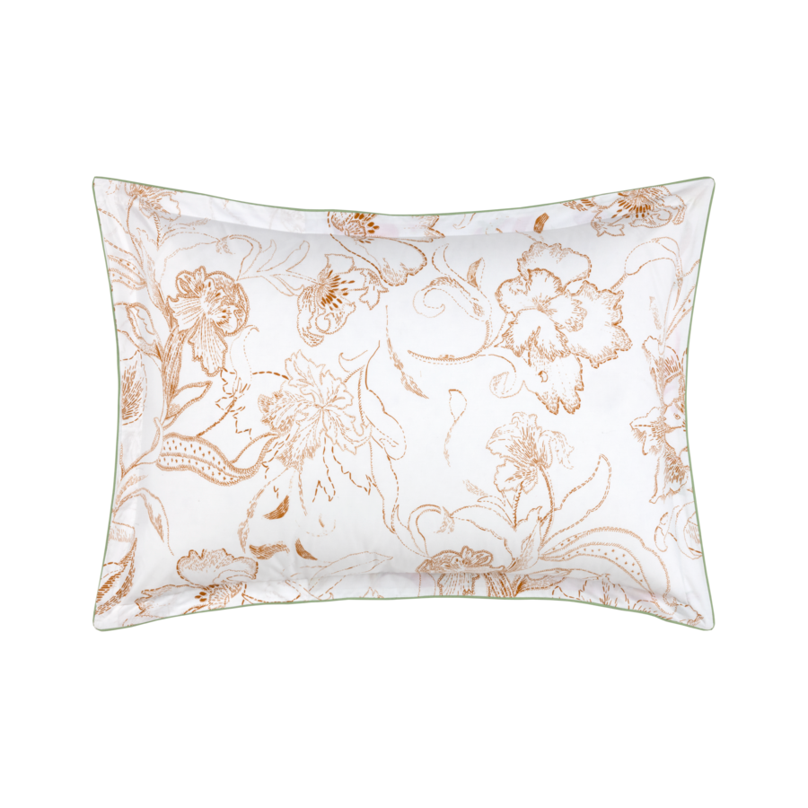 Un oreiller blanc avec un motif floral marron dessus.