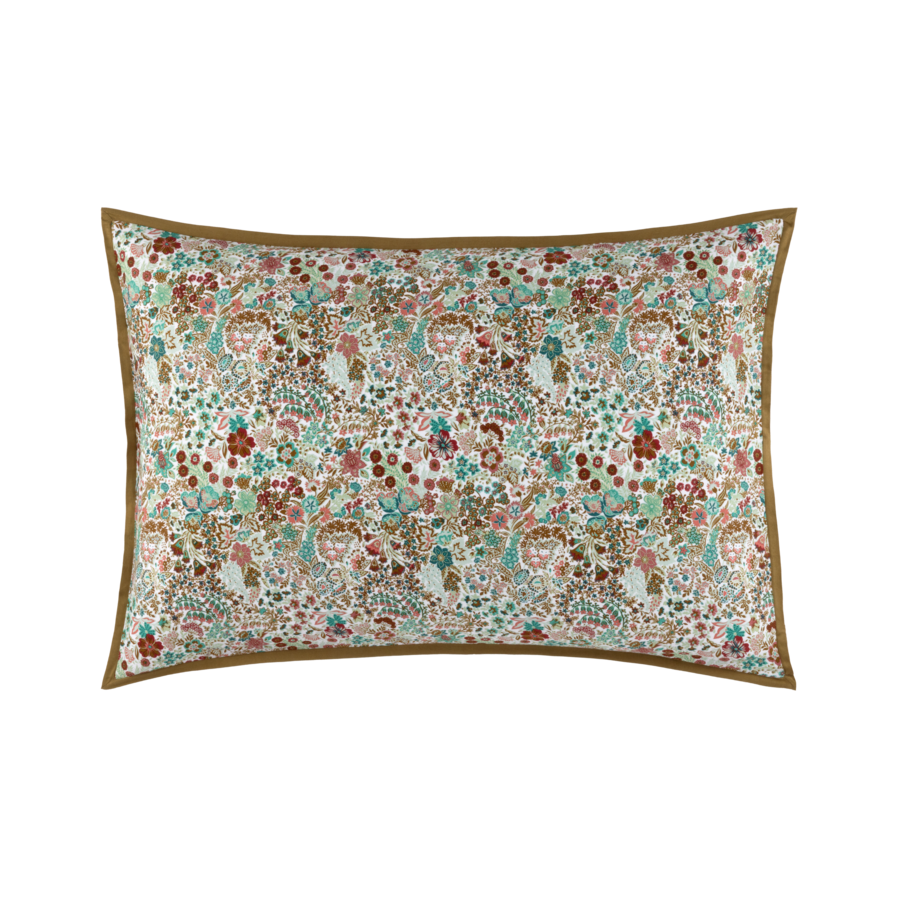 Un oreiller rectangulaire avec un motif floral dessus