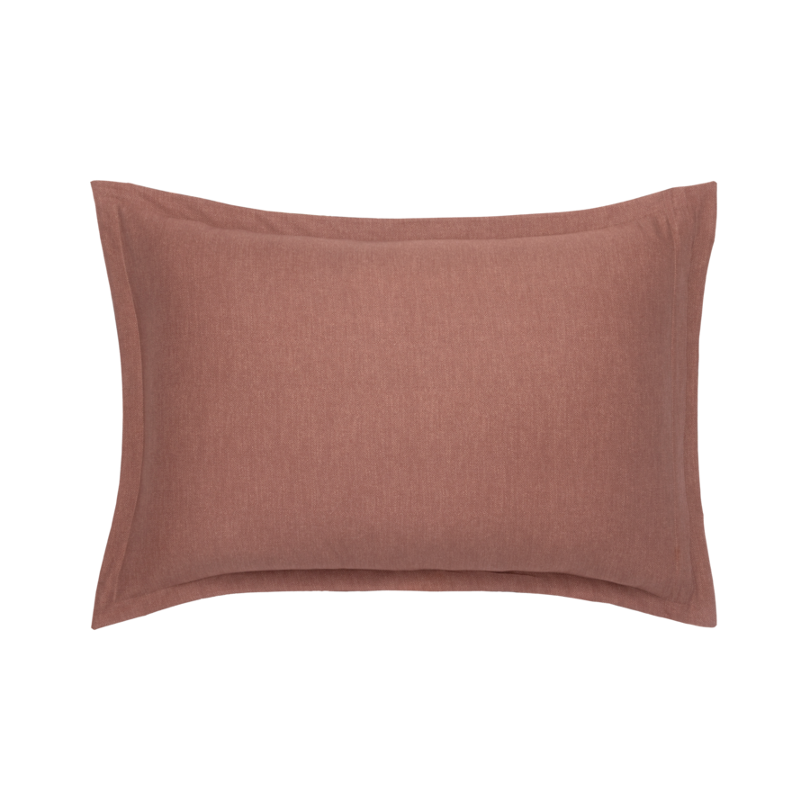 Coussin rectangulaire de couleur mauve, à la surface texturée et aux bords soignés.