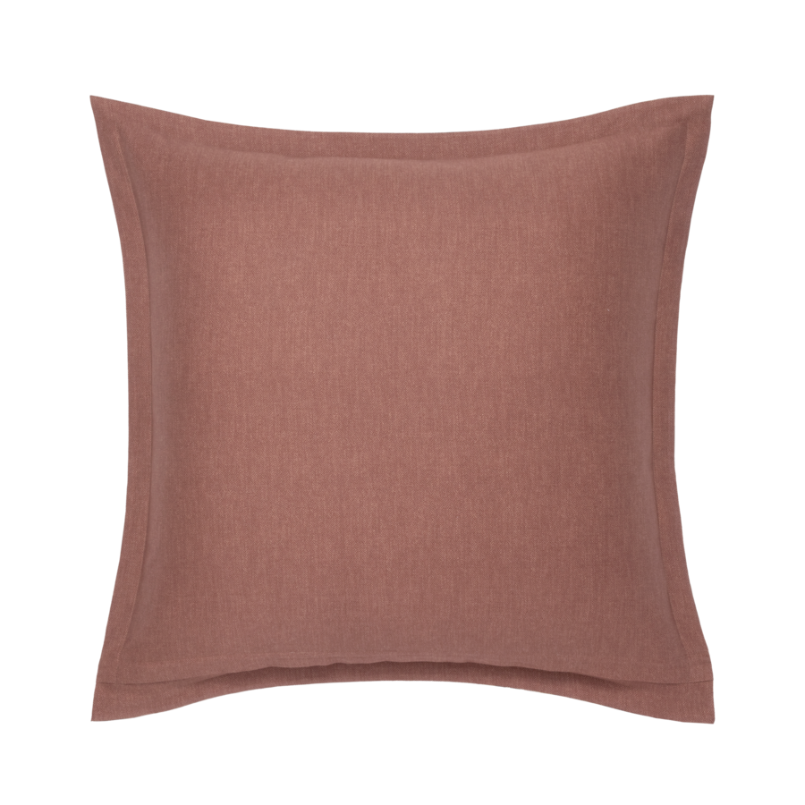 Coussin carré rose poudré avec une bordure cousue.