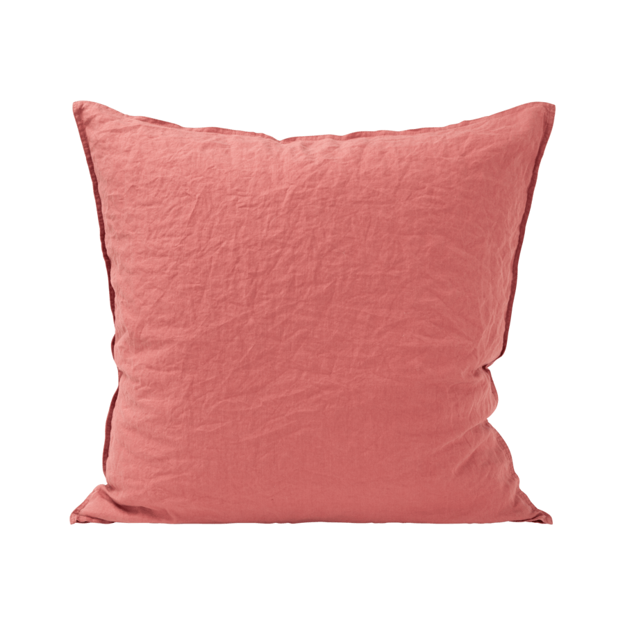 Un coussin rose avec une bordure noire sur fond blanc