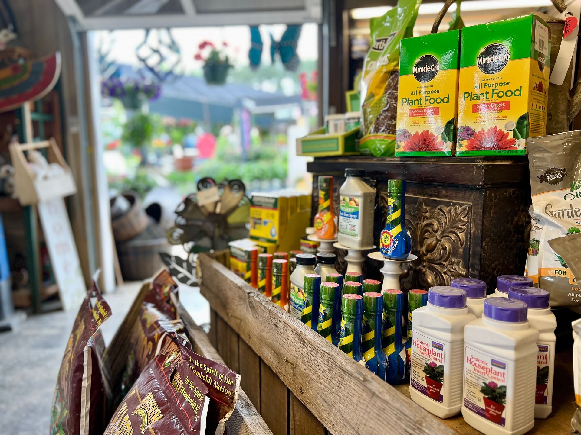 A bunch of bottles of fertilizer are sitting on a shelf in a store.