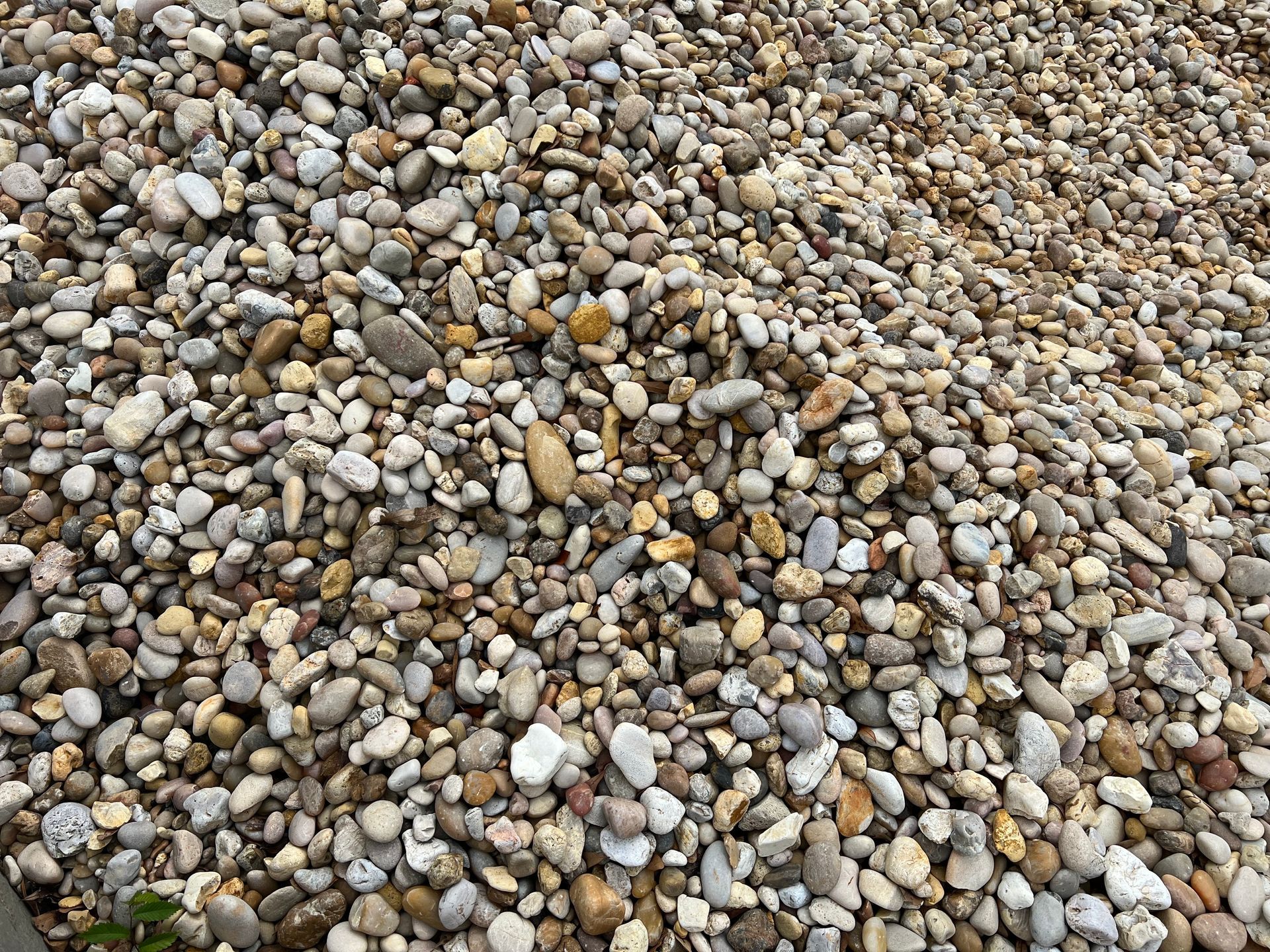 A pile of gravel is sitting on the ground.