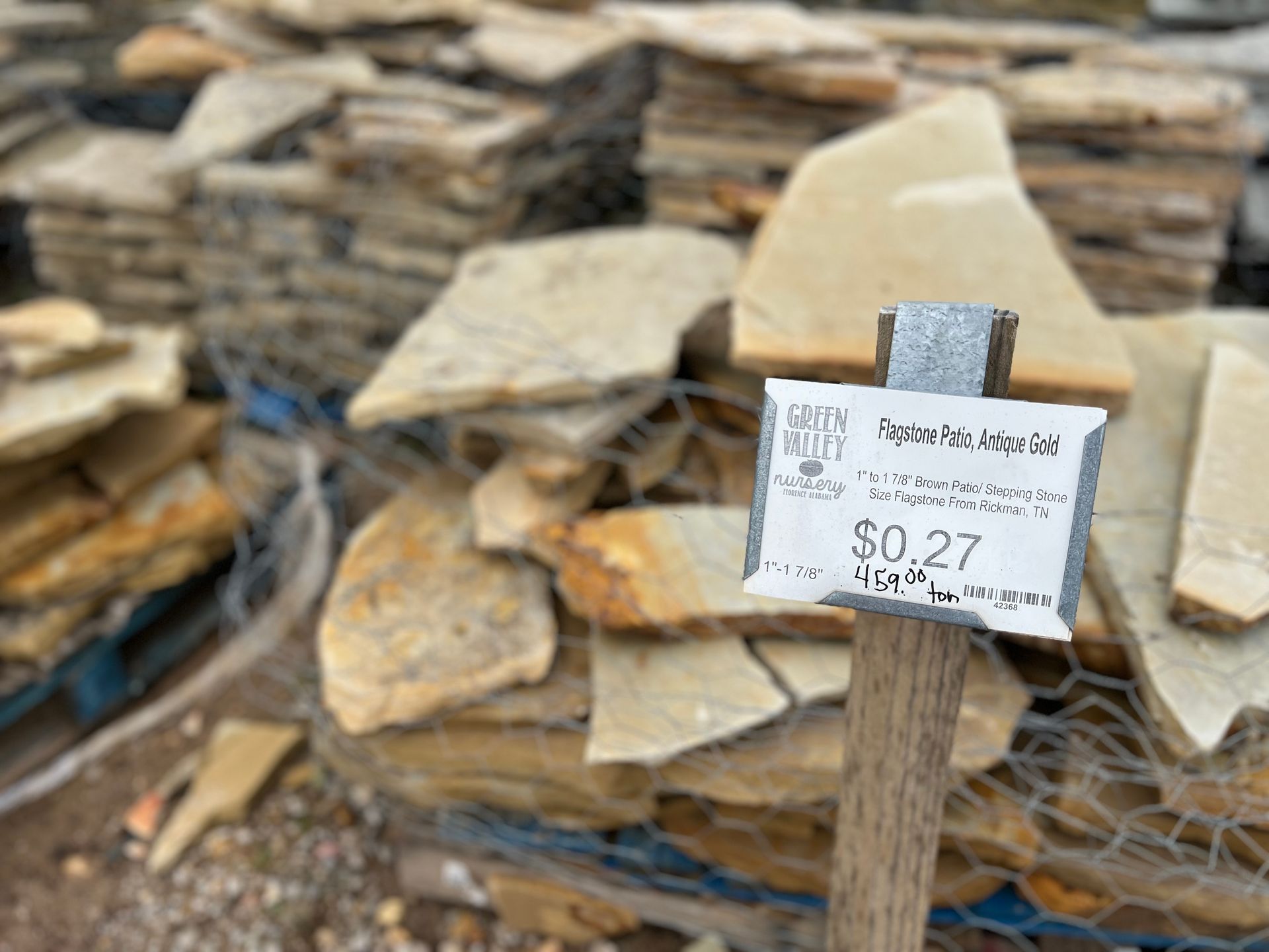 A pile of rocks with a sign that says `` $ 0.27 '' on it.