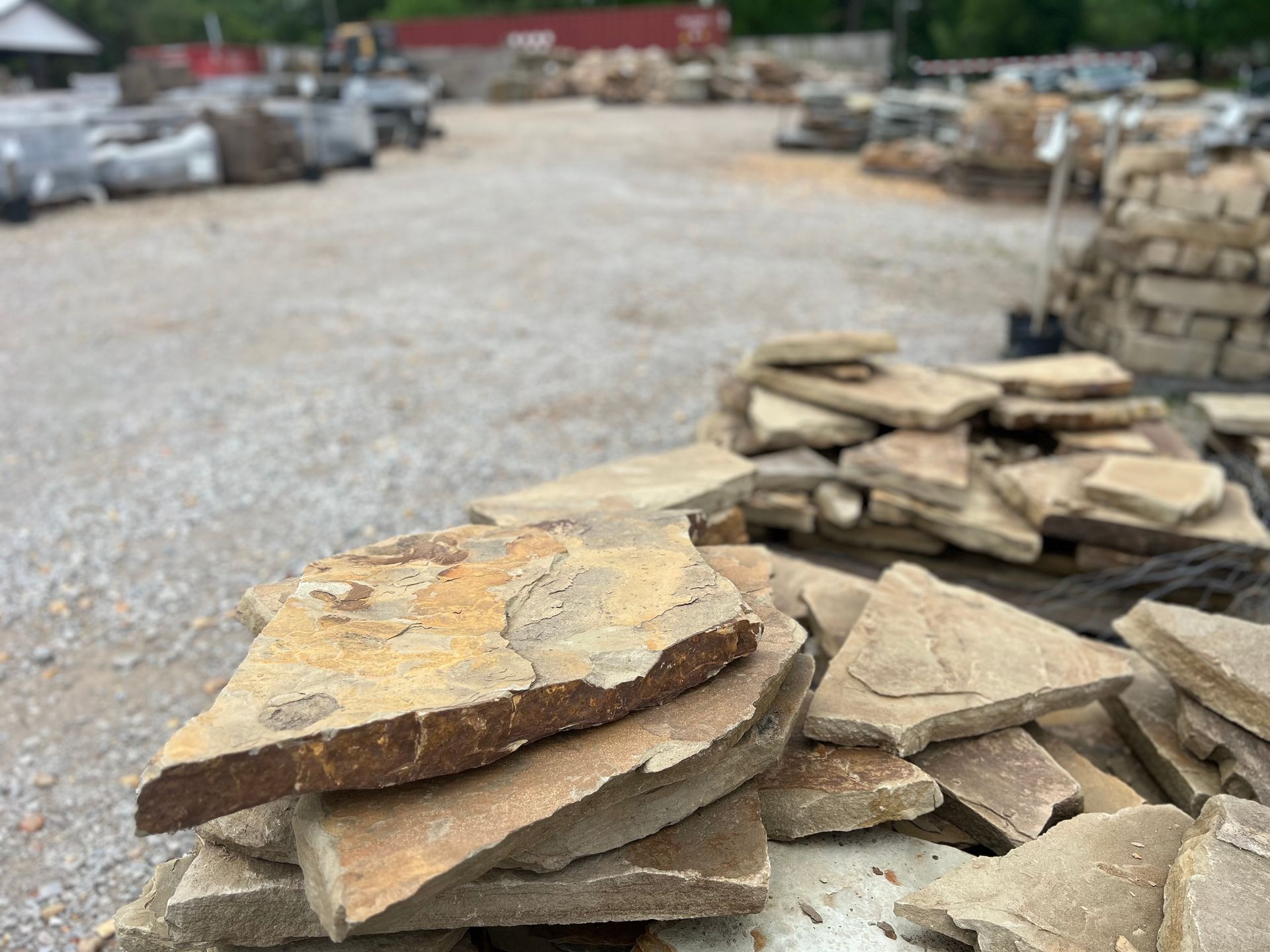 A pile of rocks sitting on top of each other on a gravel road.