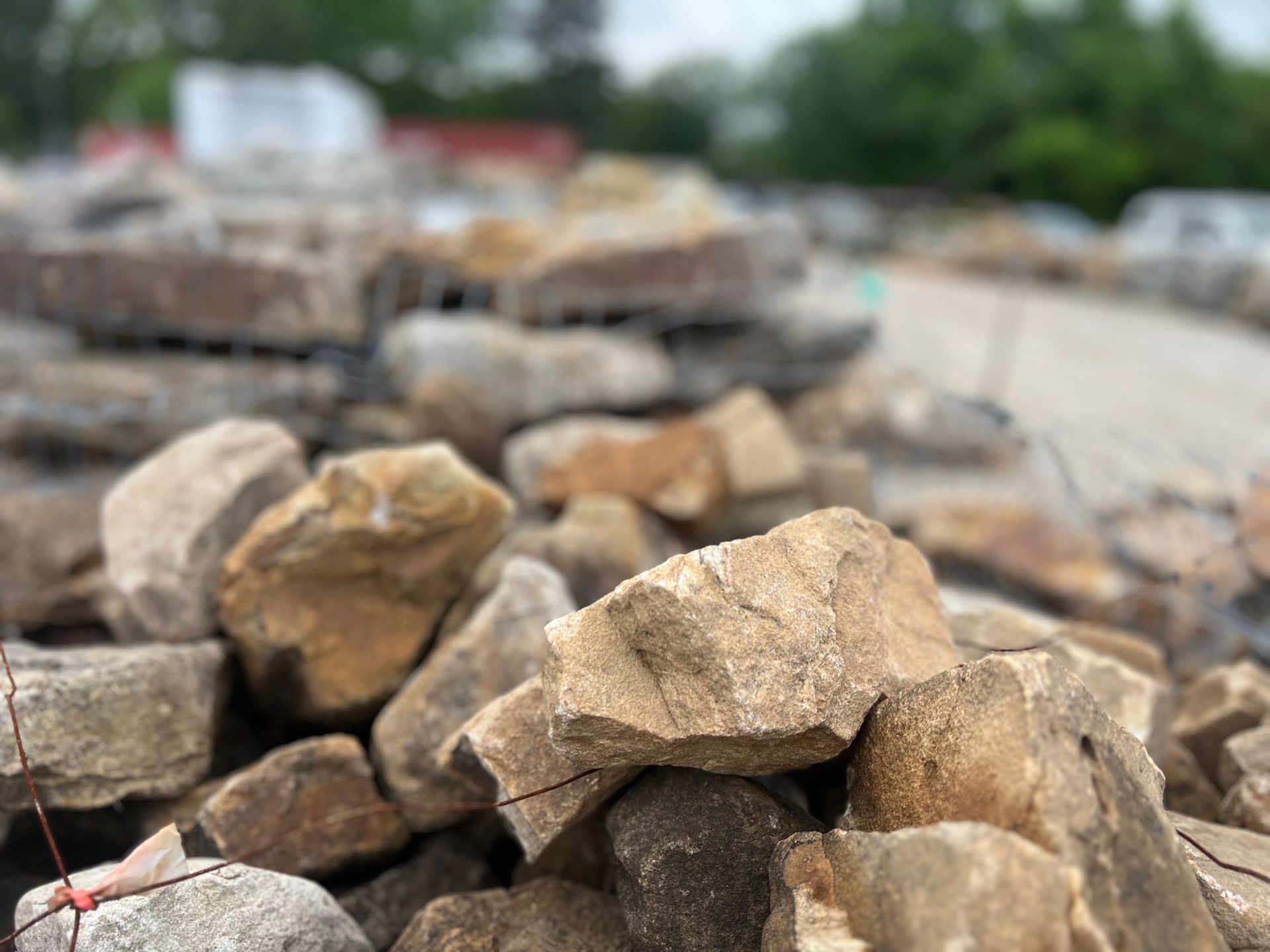 A pile of rocks sitting on top of each other on a dirt road.