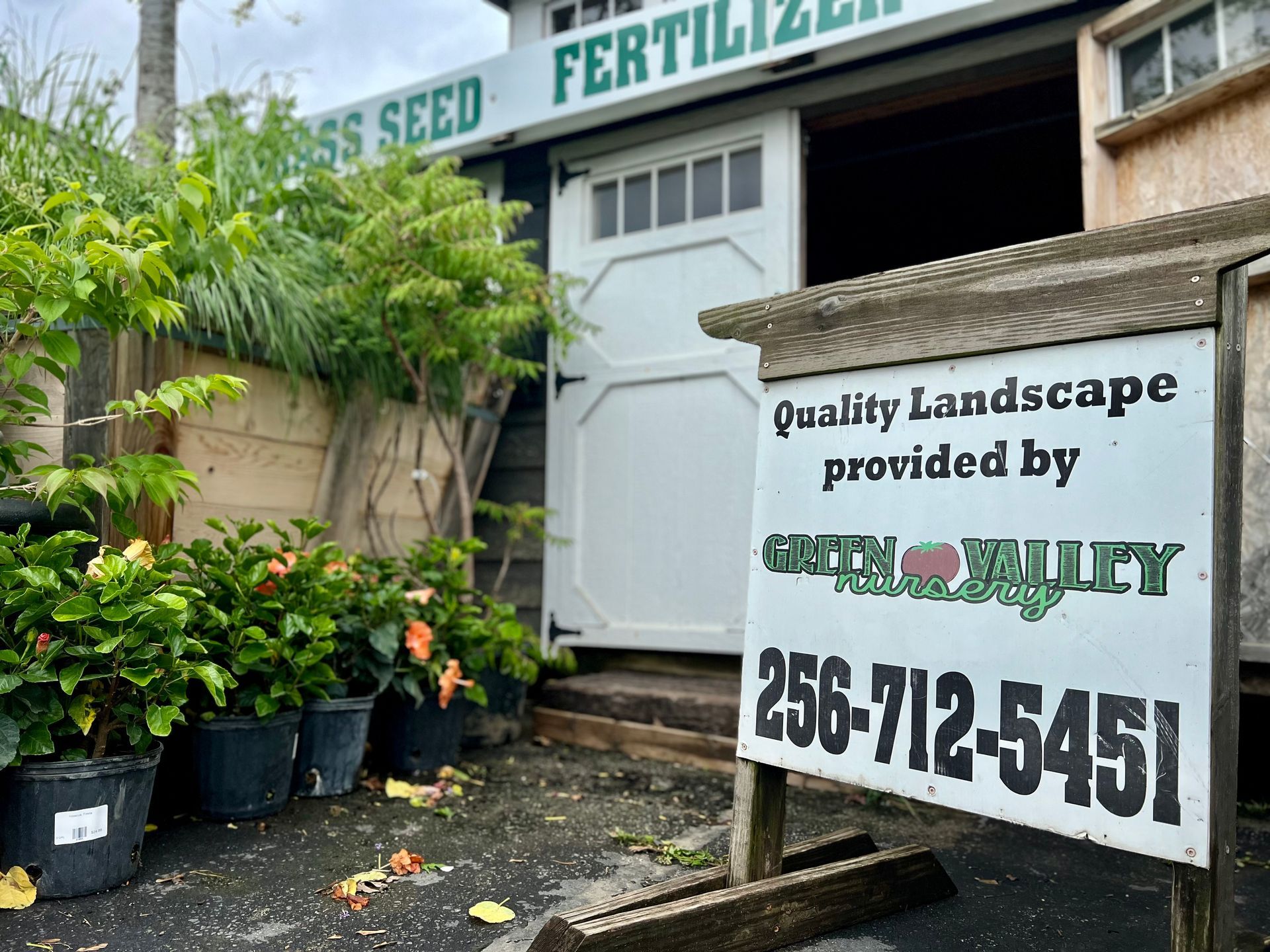 A sign in front of a building that says quality landscape provided by