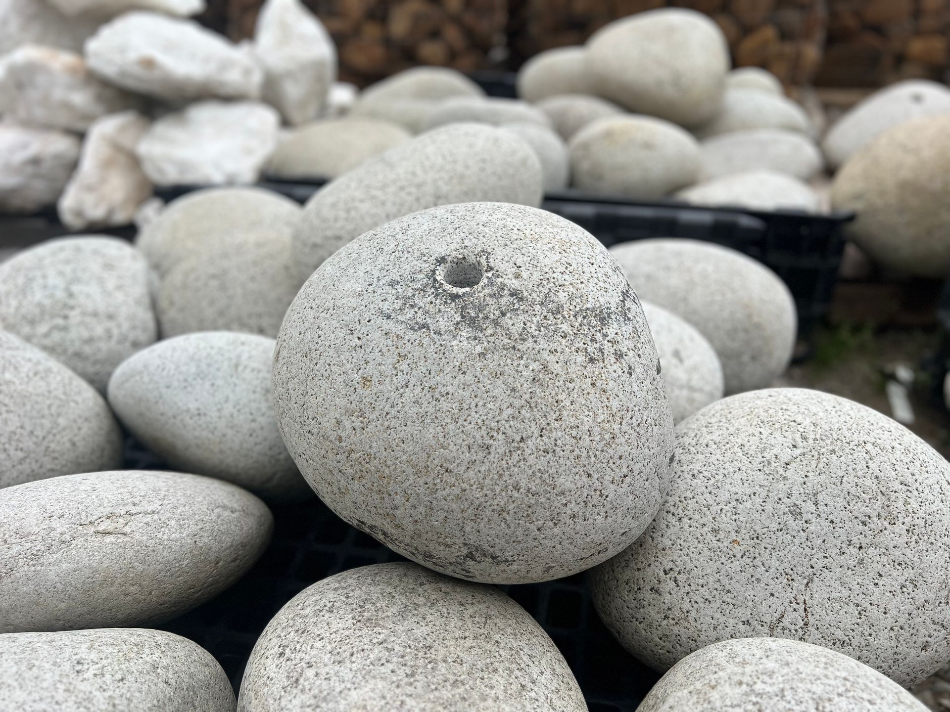 A pile of white rocks with a hole in the middle of one of them.