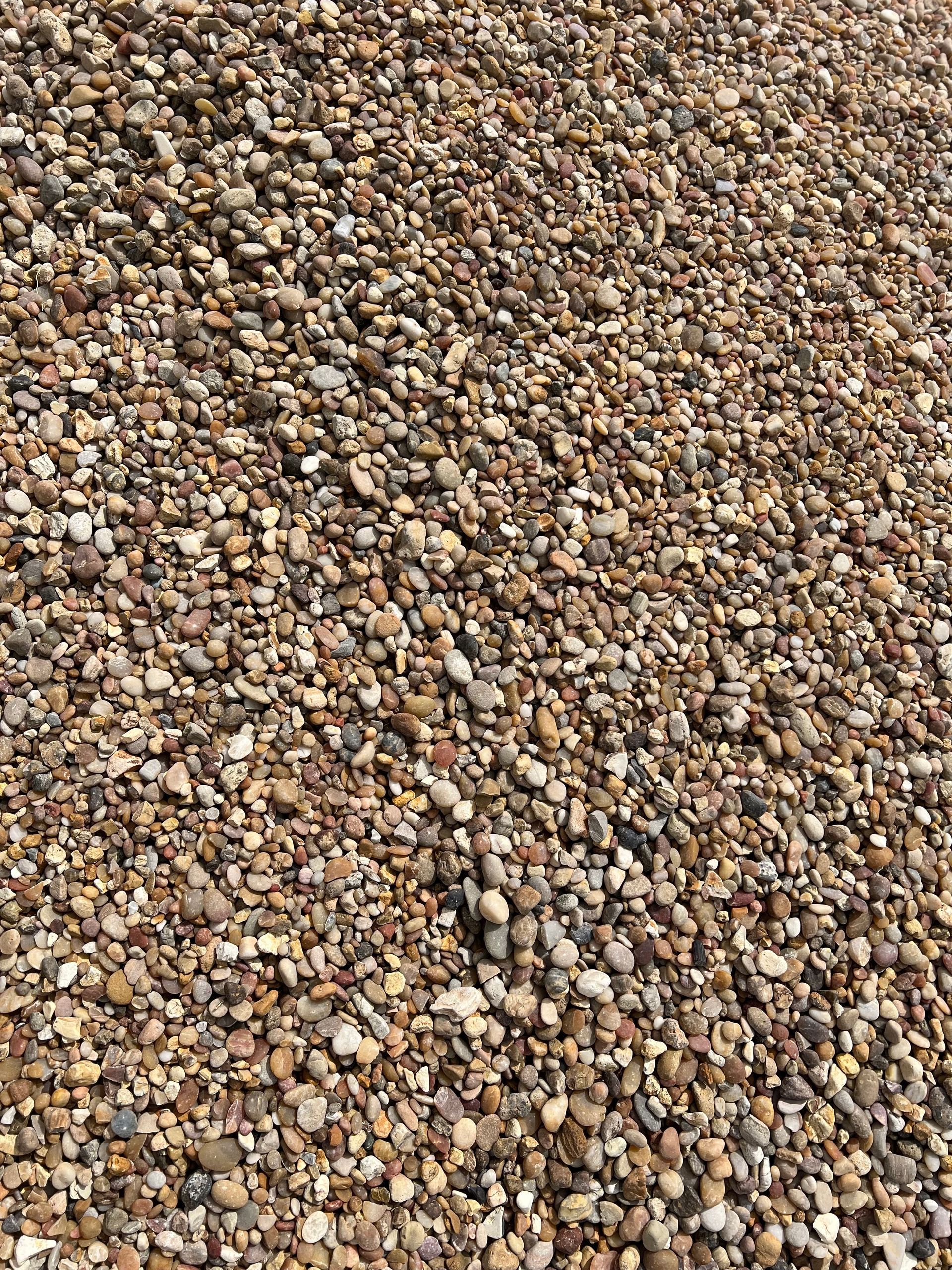 A pile of gravel is sitting on the ground.
