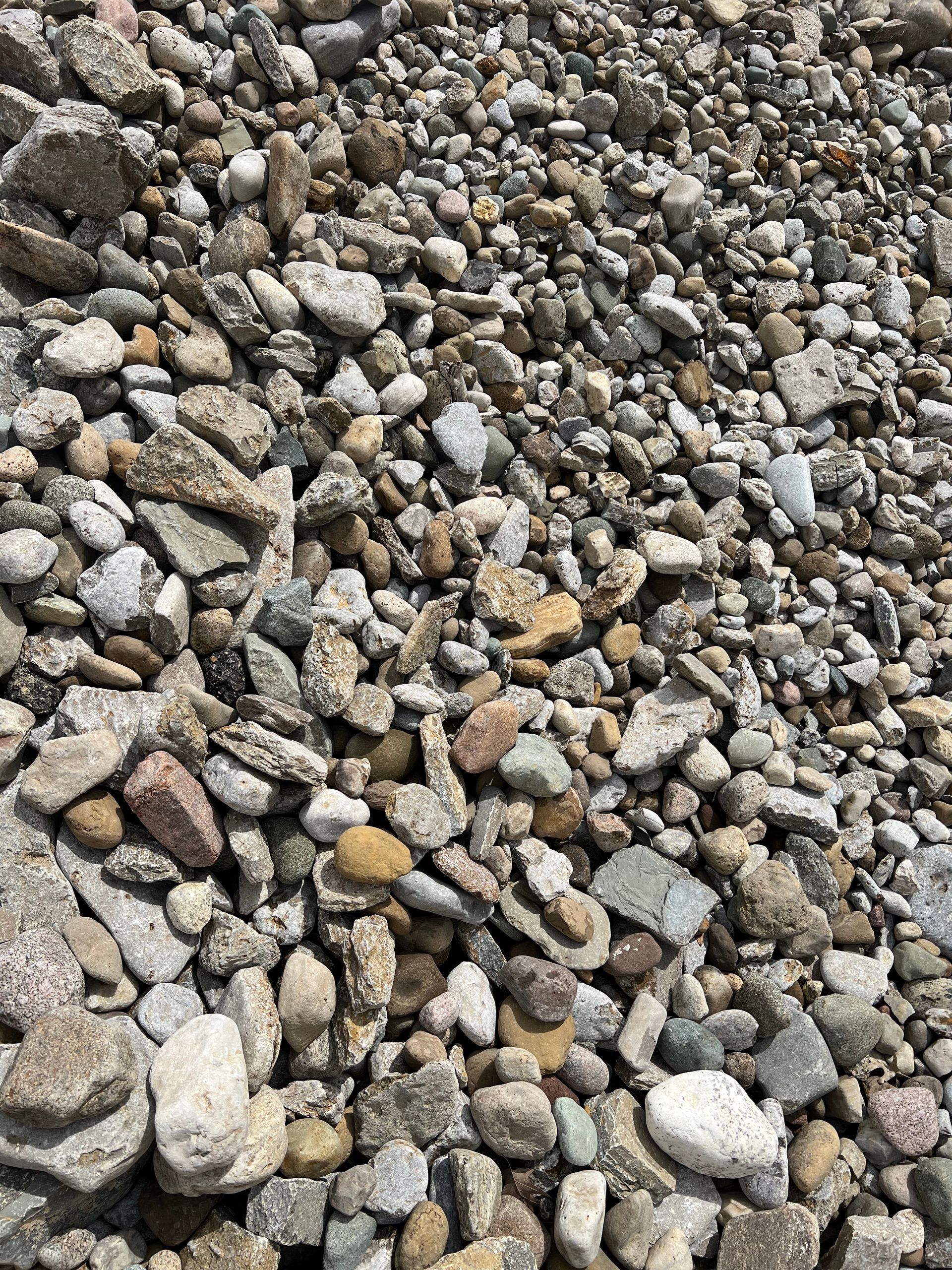 A pile of rocks sitting on top of each other on the ground.
