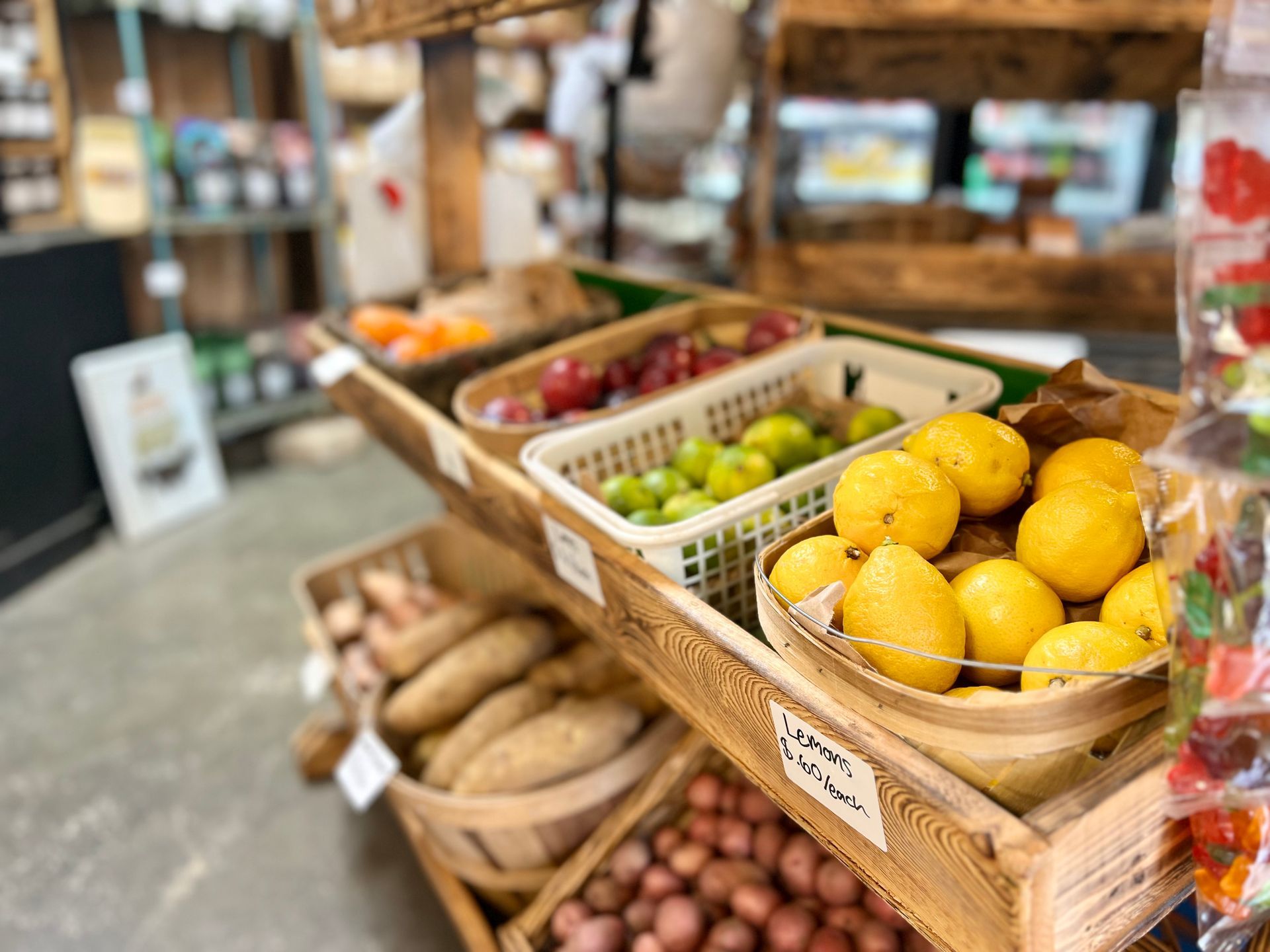 A variety of fruits and vegetables are on display in a grocery store.