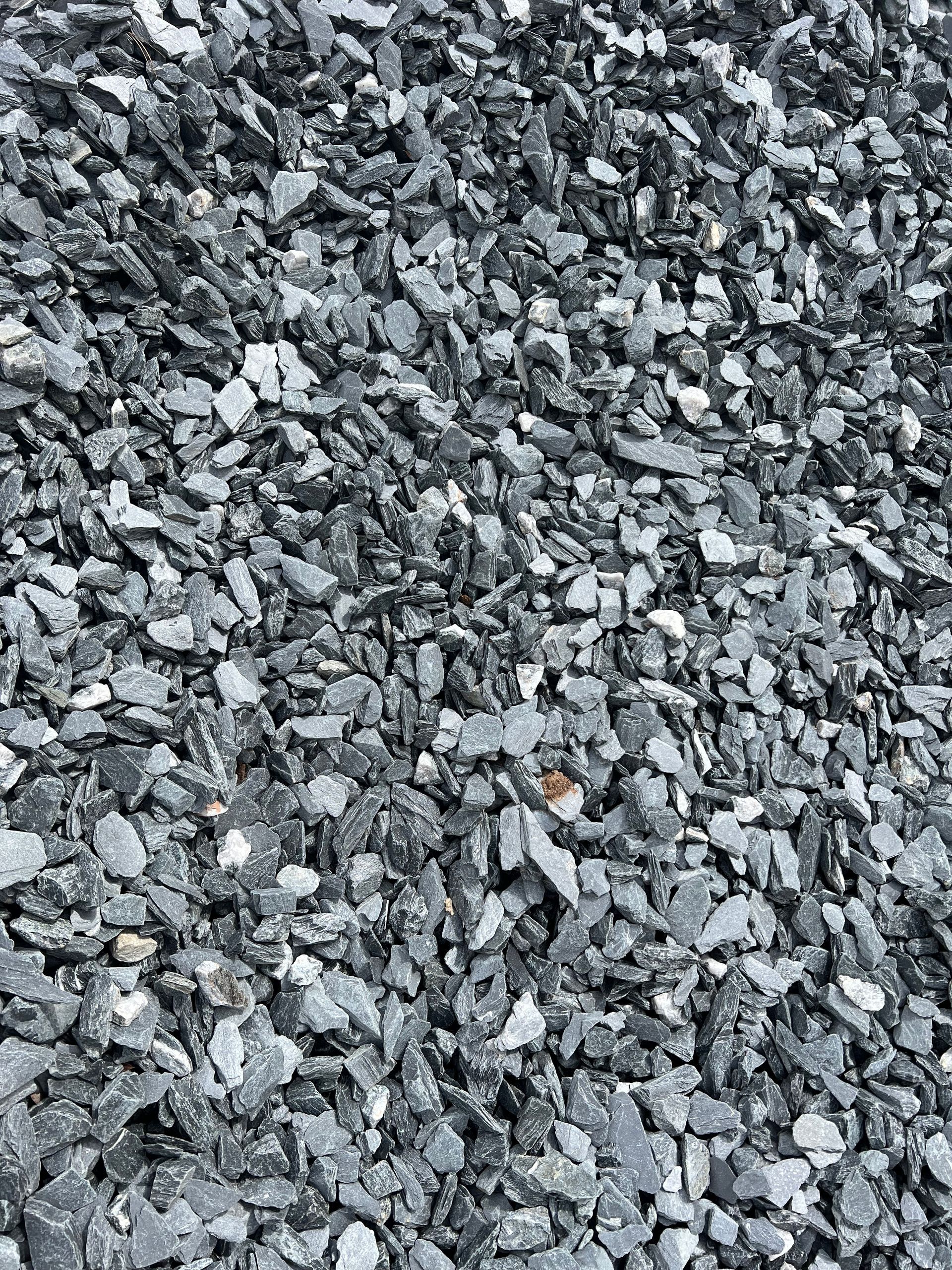 A pile of gravel is sitting on the ground.