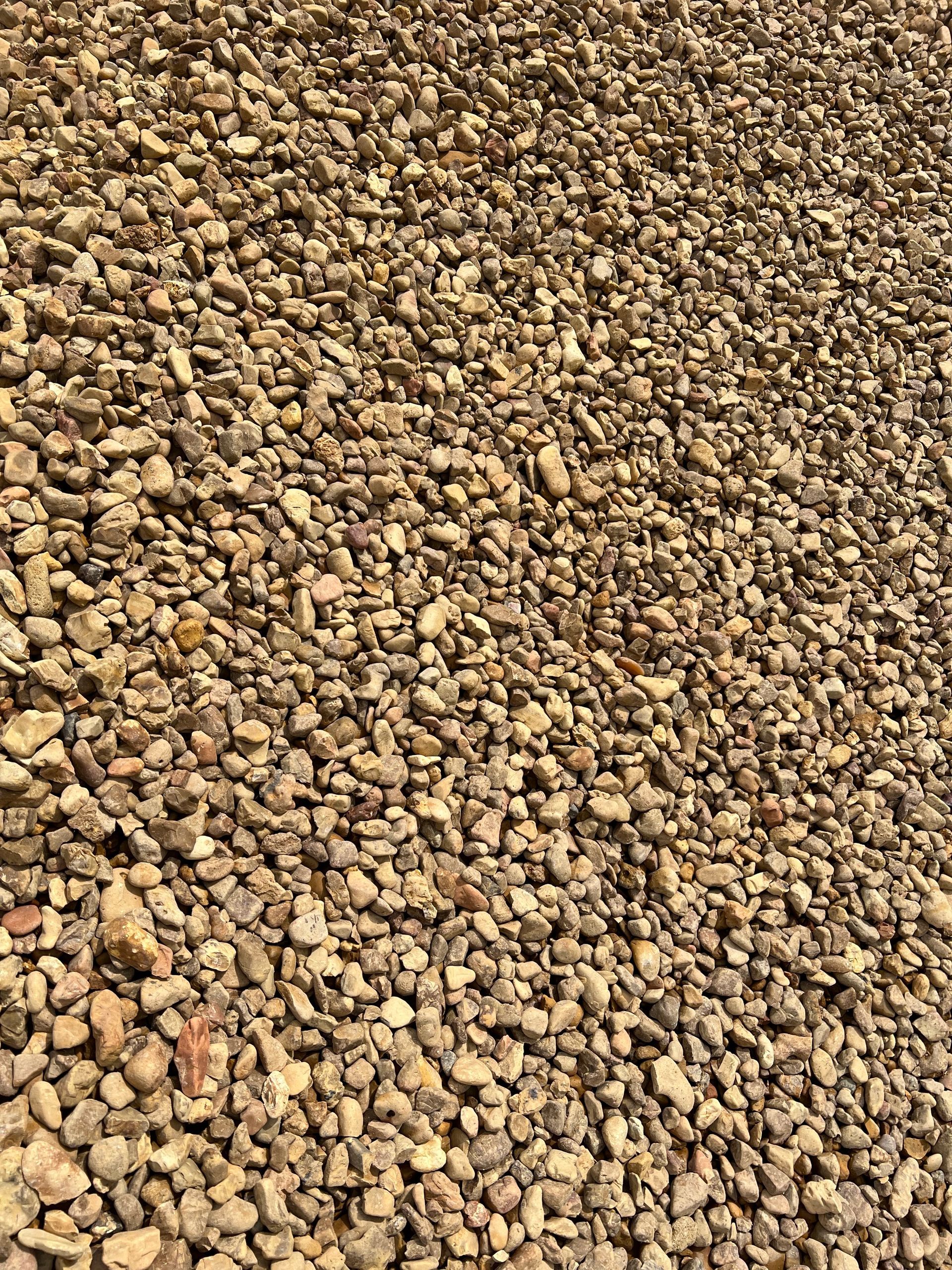 A pile of gravel is sitting on the ground.