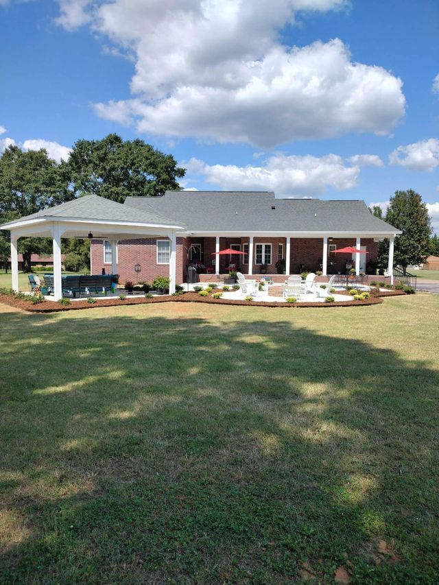 A large house with a large lawn in front of it.