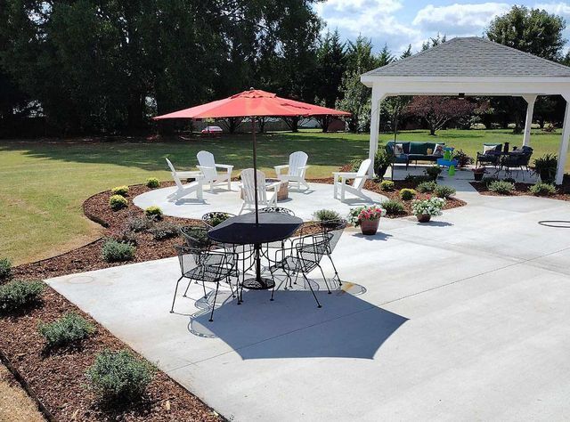 A patio with a table and chairs under an umbrella