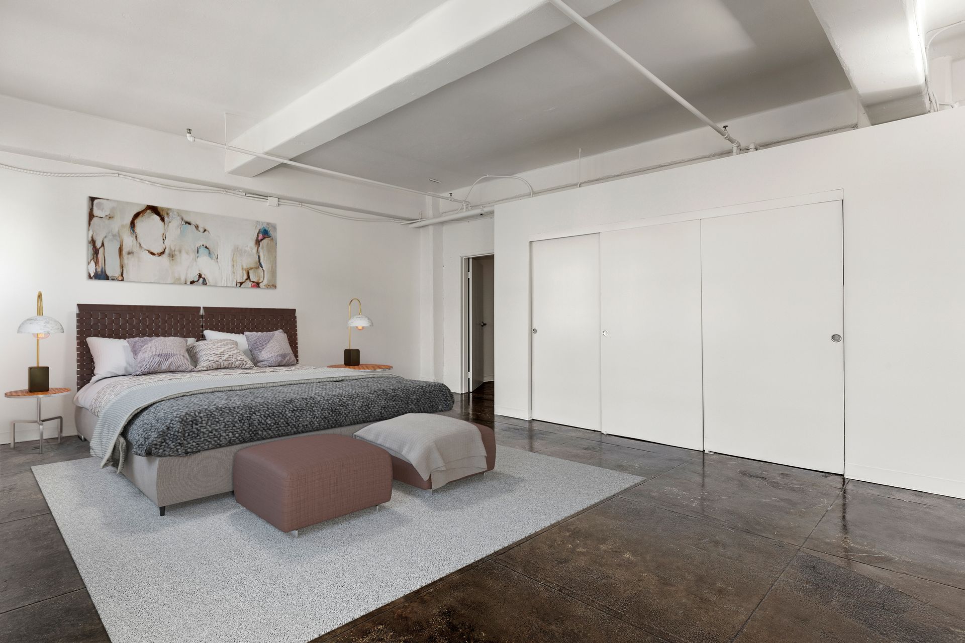 Spacious modern bedroom with a large bed, gray rug, and white closet doors