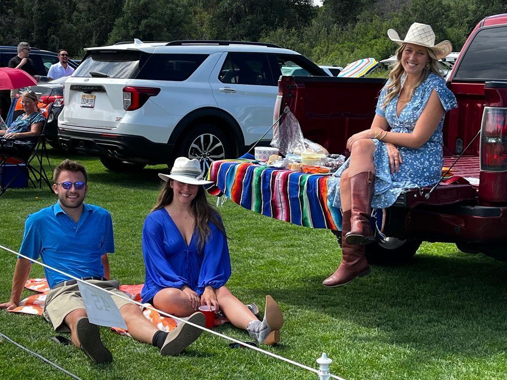 A group of people are sitting in the back of a truck.
