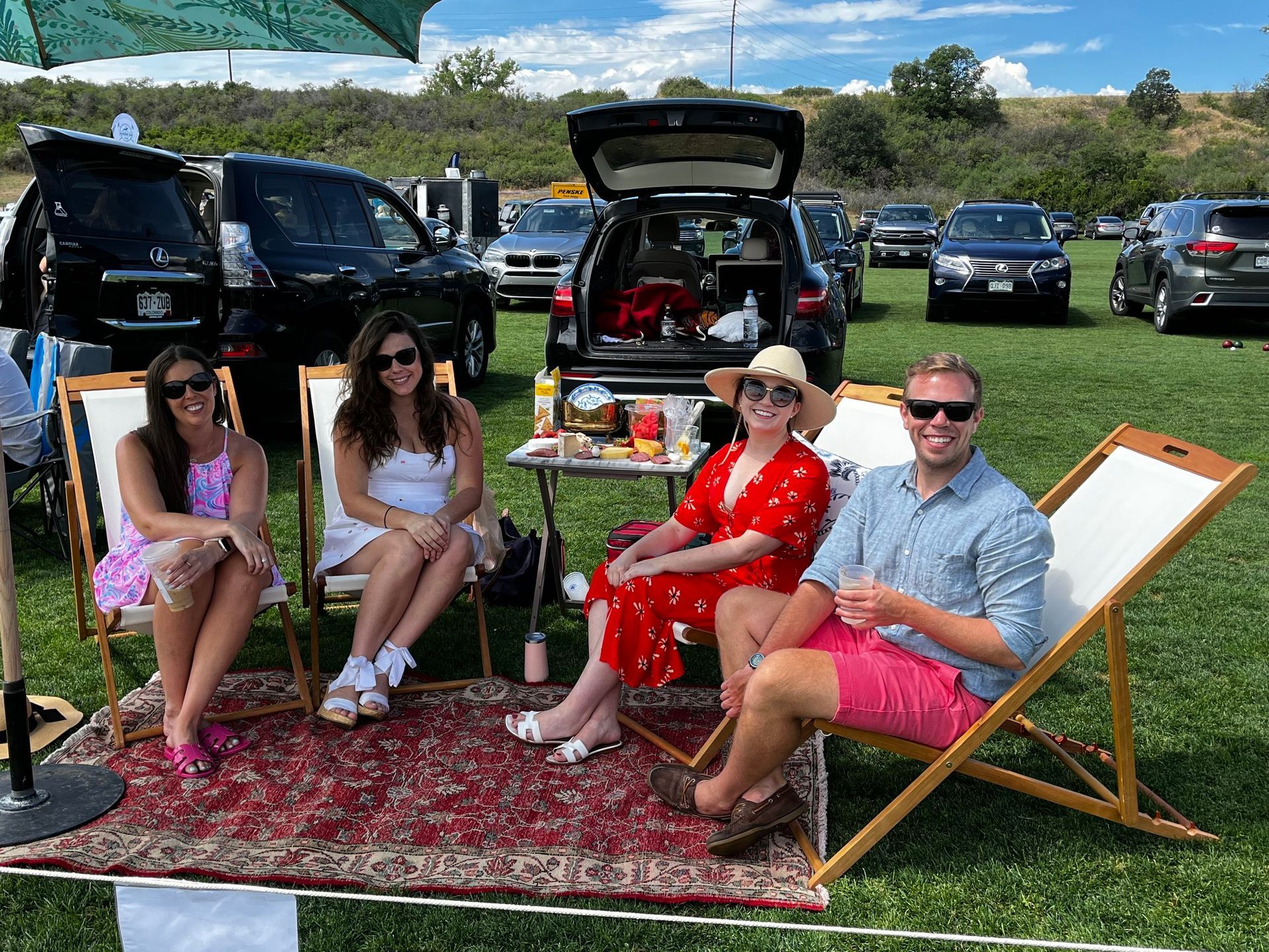 A group of people are sitting in lawn chairs in a field.