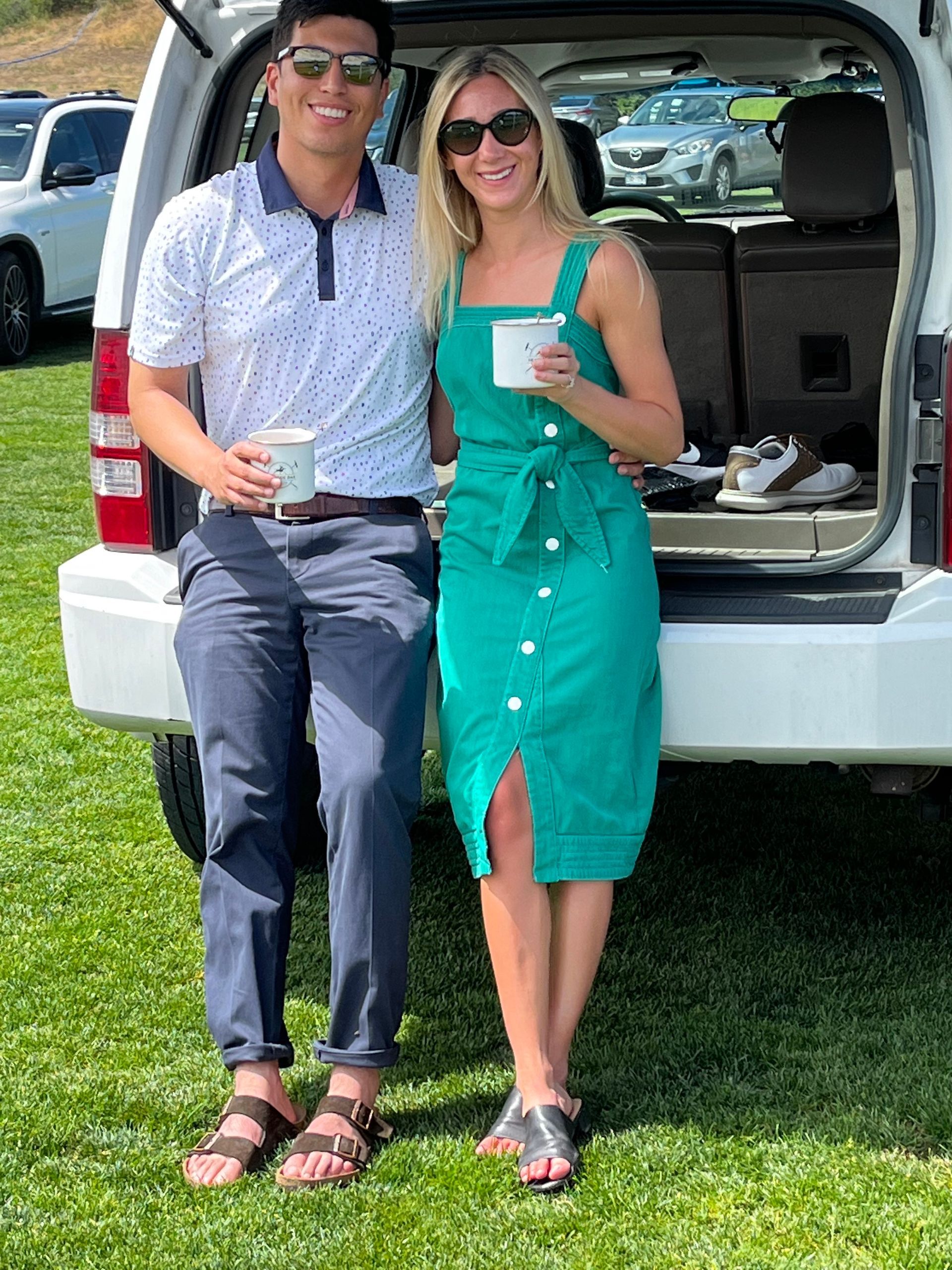 A man and a woman are sitting in the back of a car.