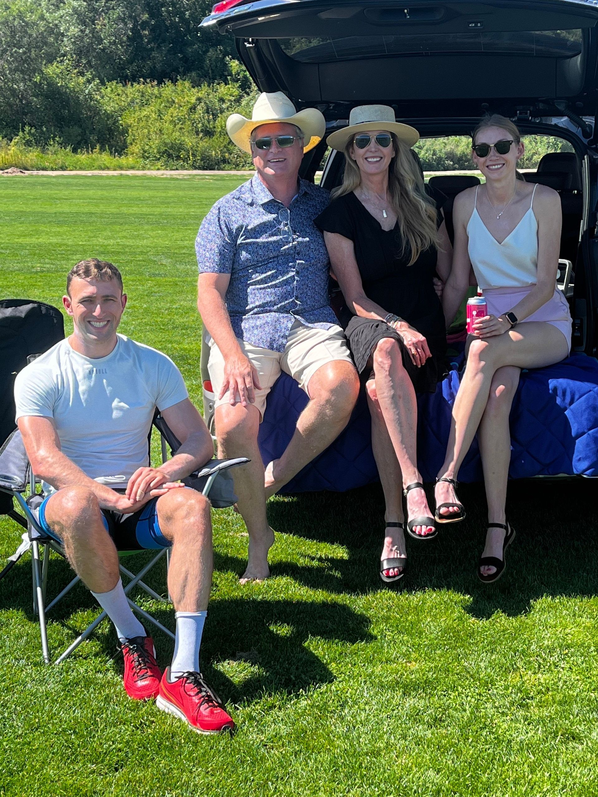 A group of people are sitting in the back of a car.