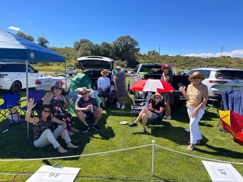 A group of people are posing for a picture in a parking lot.