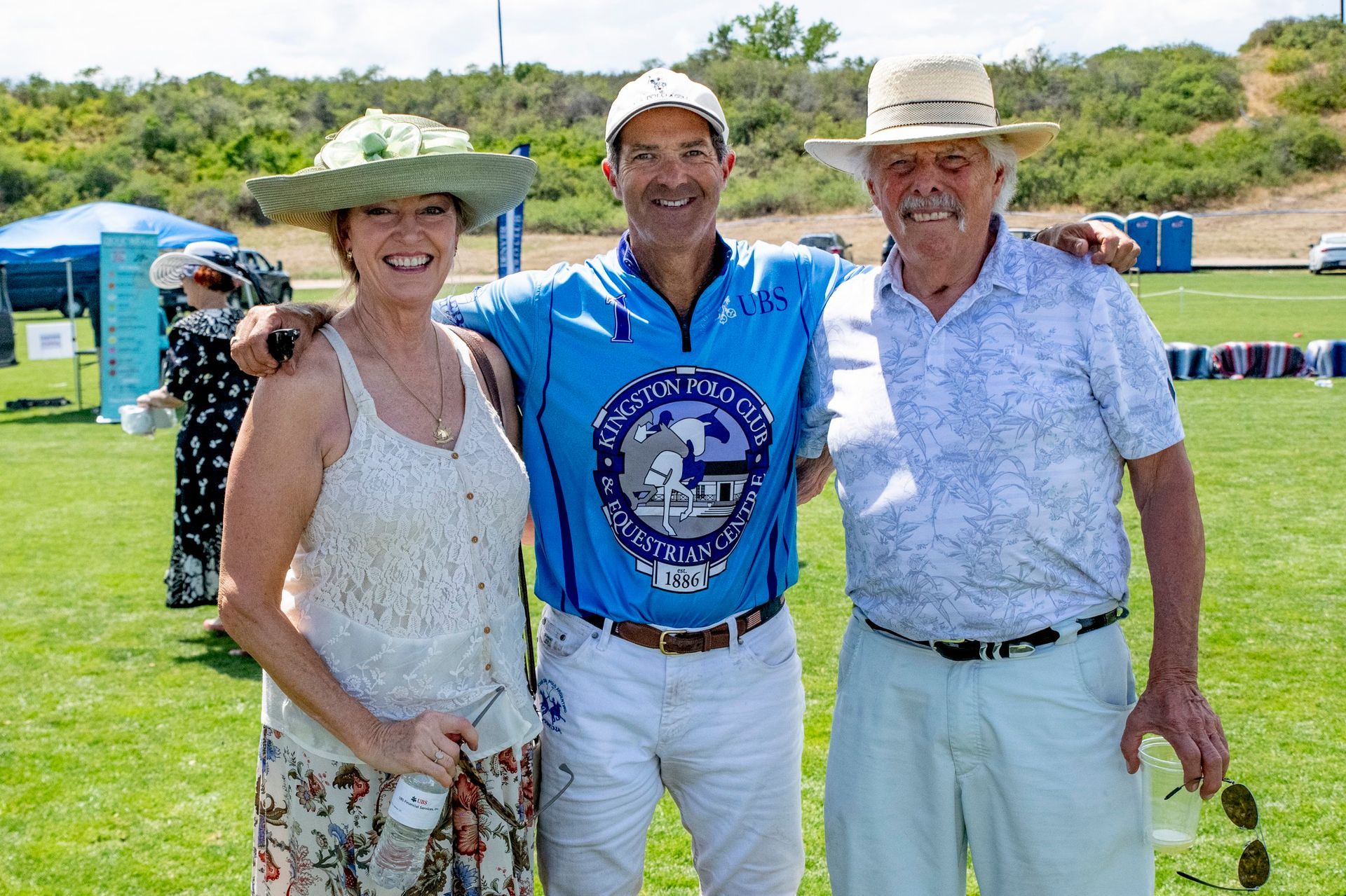 A group of people are posing for a picture on a field.