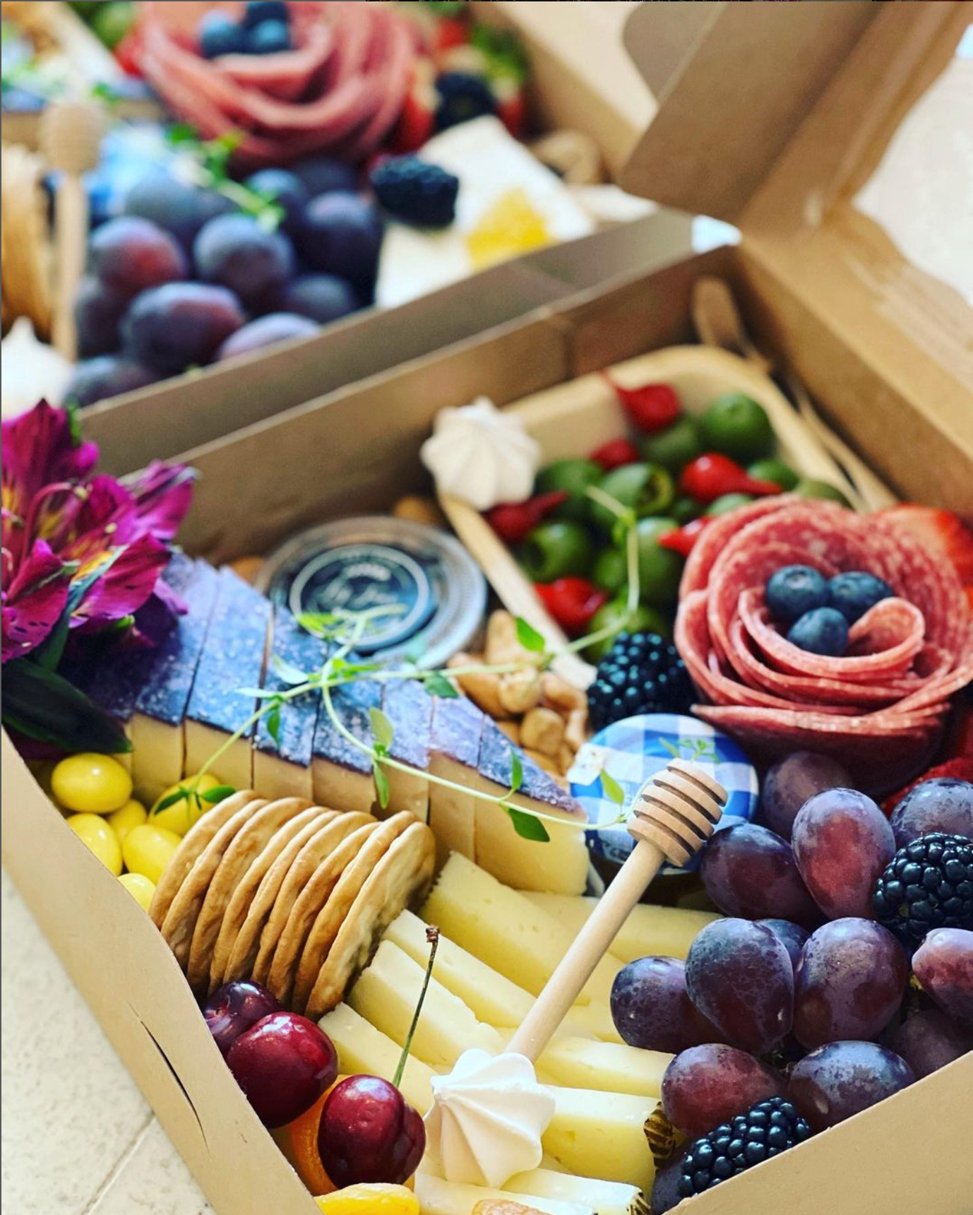 A box filled with a variety of fruits and cheeses